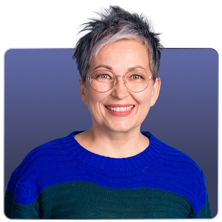 A smiling individual with short, spiky hair wearing glasses and a blue-green sweater against a gradient background.